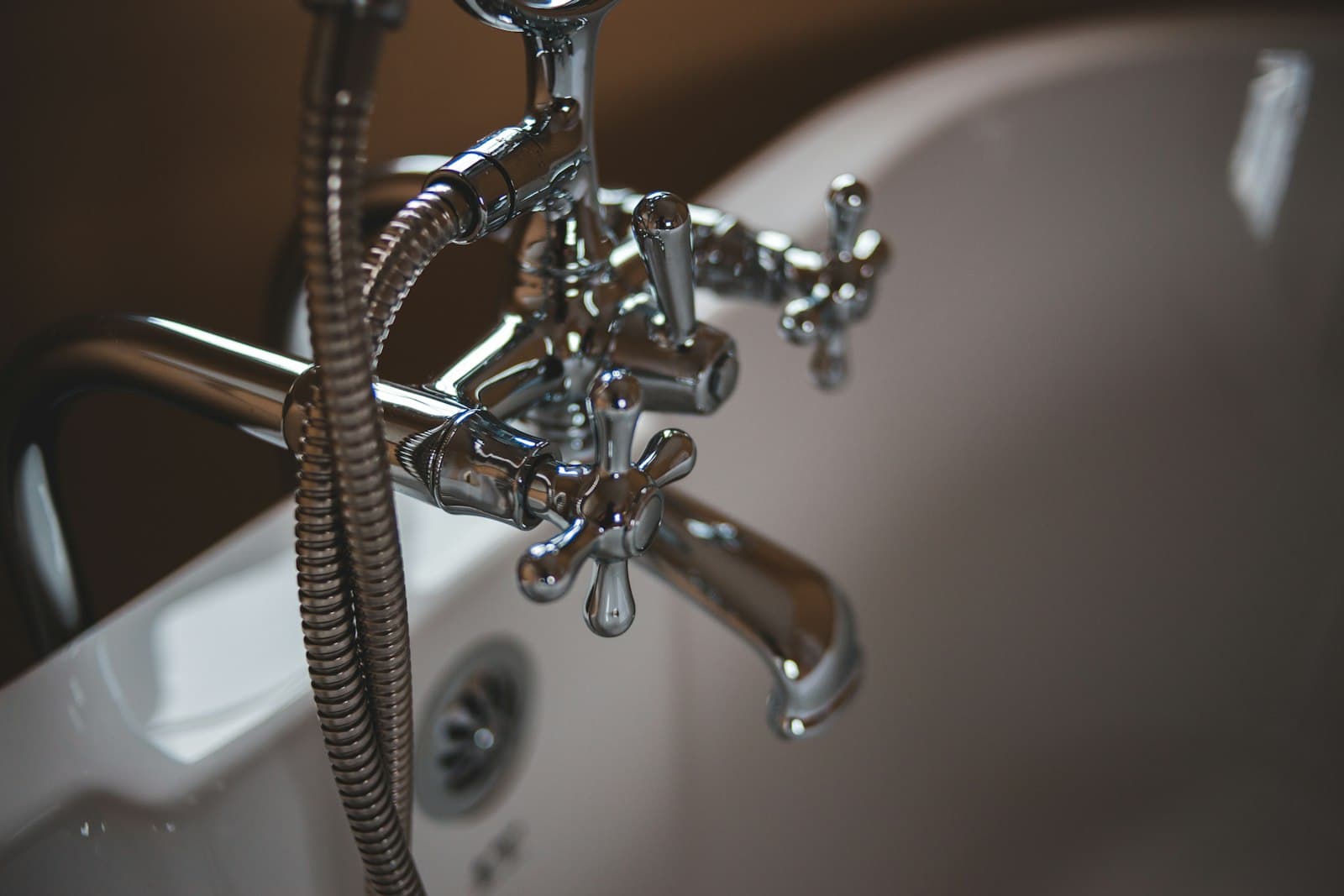 Modern brass tap with running water — plumbing fittings